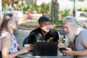 Three people sitting and talking.