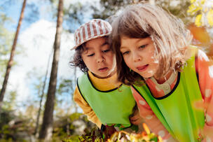  Two children in a forest environment.