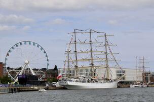 A Ferris wheel and a large sailing ship on the waterfront of Katajanokka.