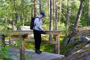 University intern Essi Kaila collecting accessibility data on the nature trail.