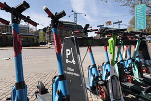 Pysäköityjä sähköpotkulautoja.