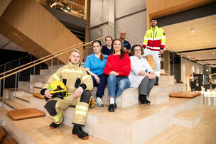 Sosiaali-, terveys- ja pelastustoimen ammattilaisia istumassa yhteiskuvassa.