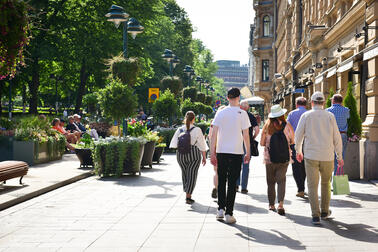 People walking on a summery street.