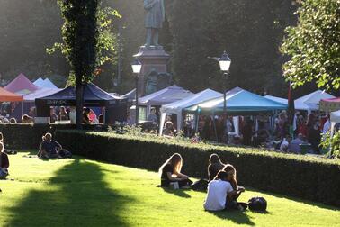 People sitting on the lawn in Esplanade Park. 