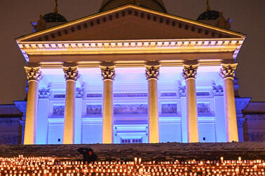 There are thousands of candles on the steps of the cathedral.