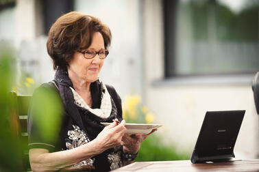 A senior resident having a meal by a remote care device.