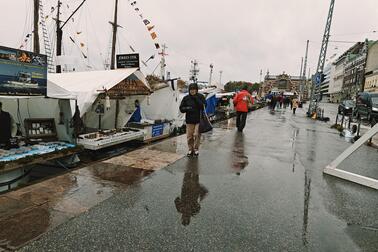 People walking in the rain at the Market Square.