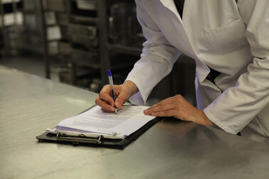 A food inspector filling out a form.