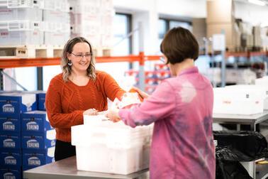 Two people handling food aid.