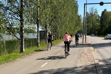 Pyöräilijöitä kadulla. 