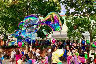 Children are playing with colourful balloons.