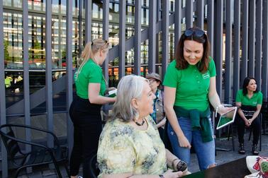 Senior info experts meeting clients at Hakaniemi market square.