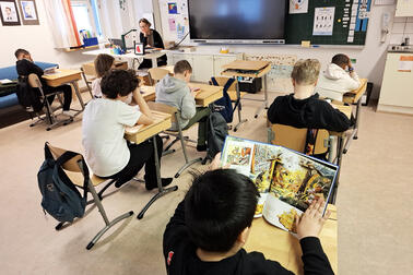 Oppilaita luokassa lukemassa omilla paikoillaan.