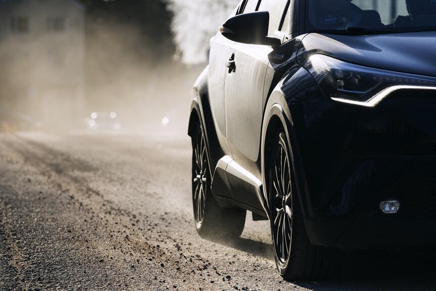 Street dust and a car on a road.