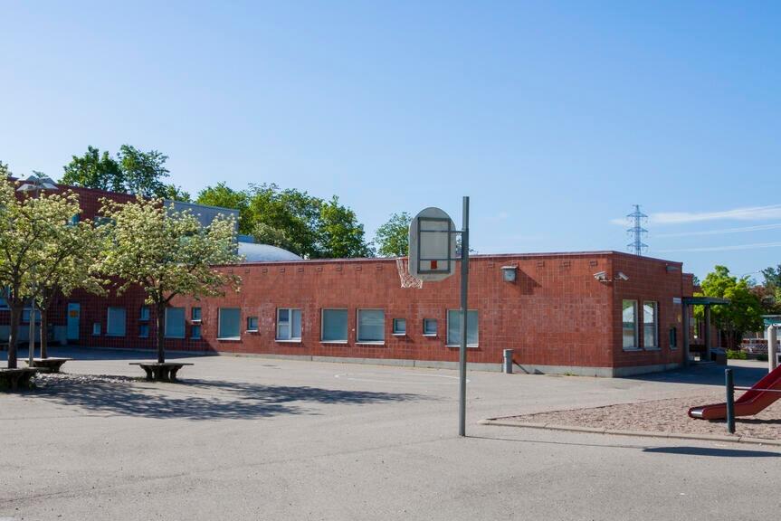 Blue sky, asphalt field and a building.