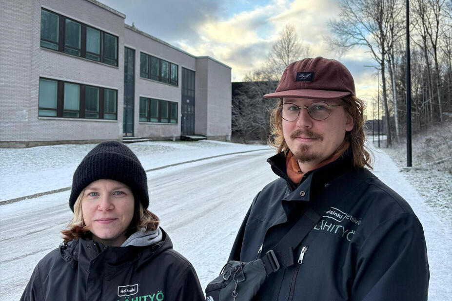 Kaksi henkilöä seisoo kadulla.