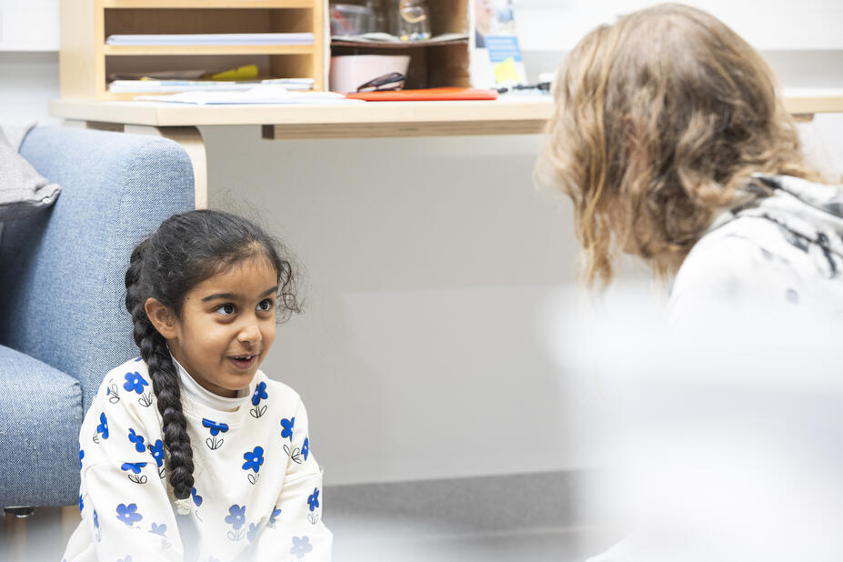 Child talking to a teacher