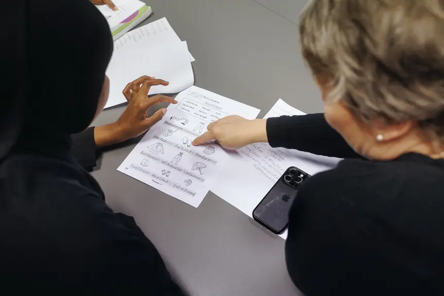  Two people looking at papers.