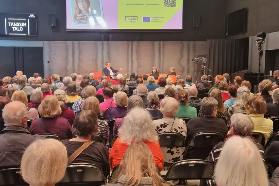 People listening to the discussion on stage.