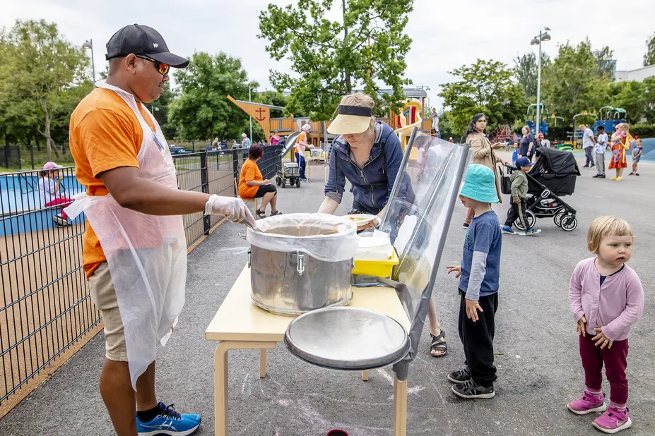 The staff distributes food in the park.