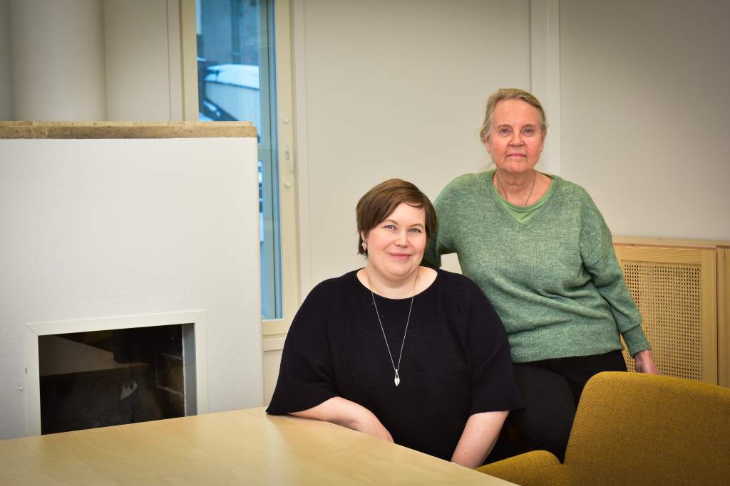 Daghemsföreståndarna (från vänster till höger) Kaisa Viitanen och Lise-Lotte Ekberg-Tallqvist i personalens mötesrum på översta våningen. I mötesrummet finns den ursprungliga eldstaden kvar. Bild: Teina Ryynänen