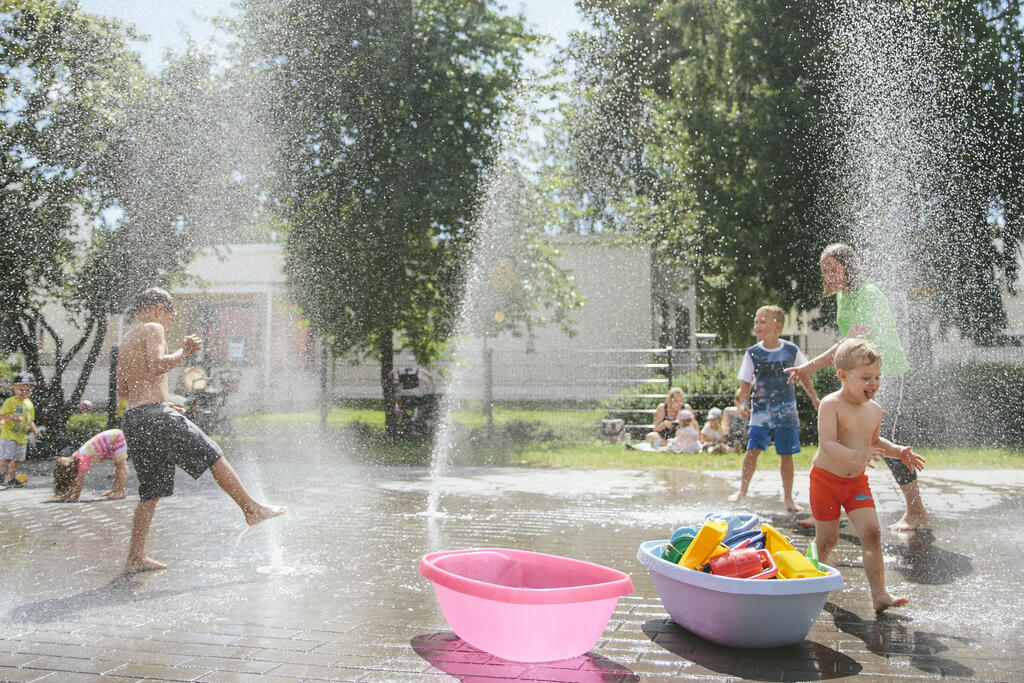 Lapsia leikkii leikkipuistossa vesisuhkussa