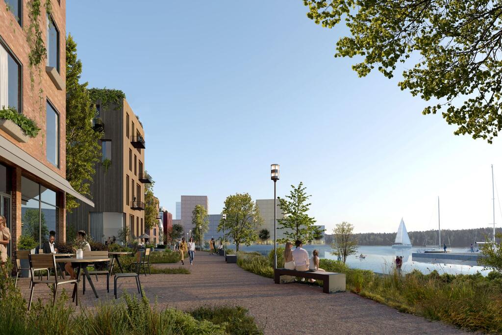 Botbygårdsstranden ska bli ett grönt och havsnära bostadsområde. I bakgrunden syns bostadskvarteret som byggs på en konstgjord ö. Bild: Voima Graphics Oy
