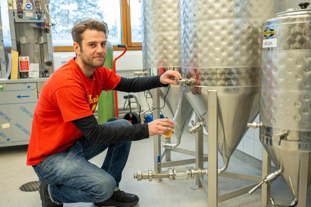 Valtteri Lehtelä presenterar bryggeriets 240 liter stora jäsningskärl. Kullervogatans bryggeris pale ale har en stark humlearom. Bild: Ilkka Ranta-aho