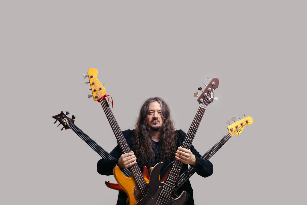 Lauri Porra with four bass guitars.