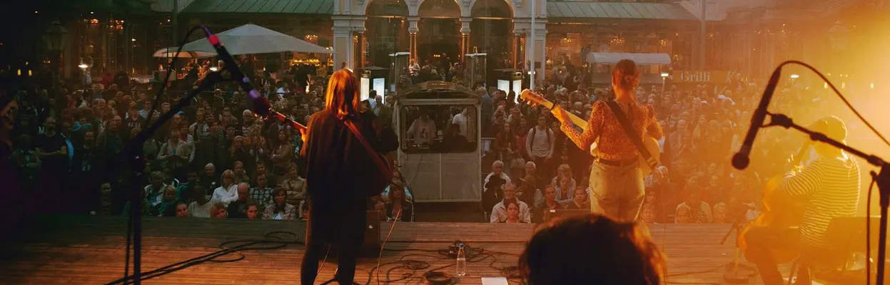 The music band plays on Espa's stage and there is a lot of audience in front of the performance stage.