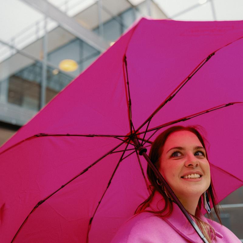 Woman holding pink umbrella