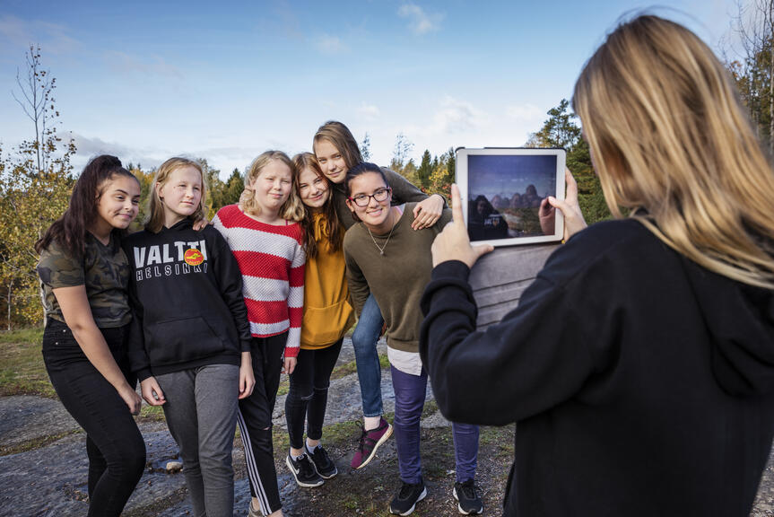 Pupil takes a photo or peers