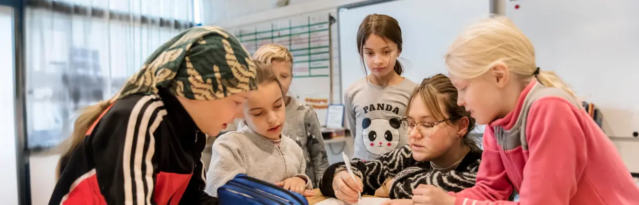 Children in class with teacher.