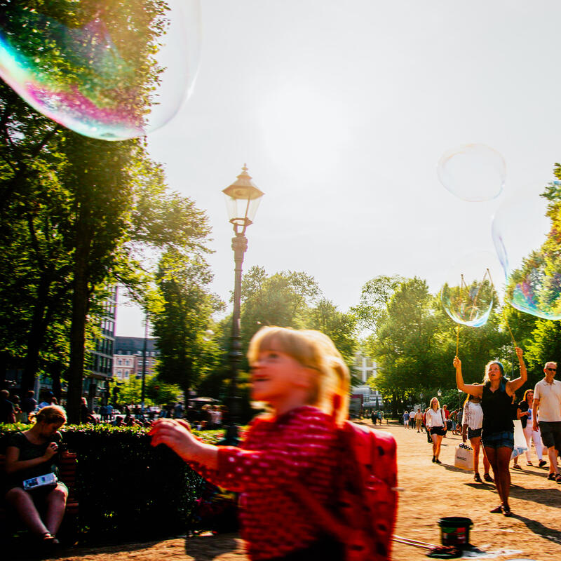 A child blows soap balloon in Esplanadi park in the centre of Helsinki.