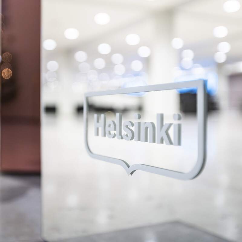 White Helsinki logo in the lobby of the cityhall.