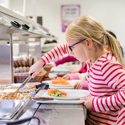 A pupil taking school lunch.