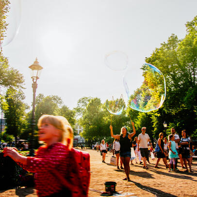 A child blows soap balloon in Esplanadi park in the centre of Helsinki.