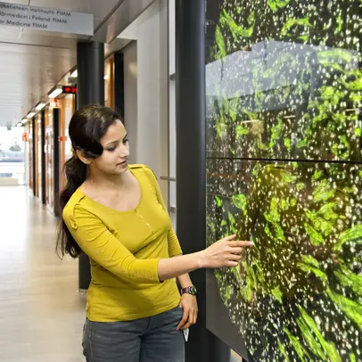Woman touching a smart screen.