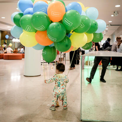 Child with balloons at Helsinki Welcome Day