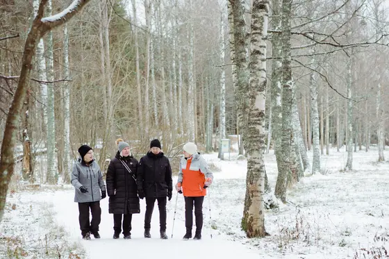 People outdoors in winter, standing in a line.
