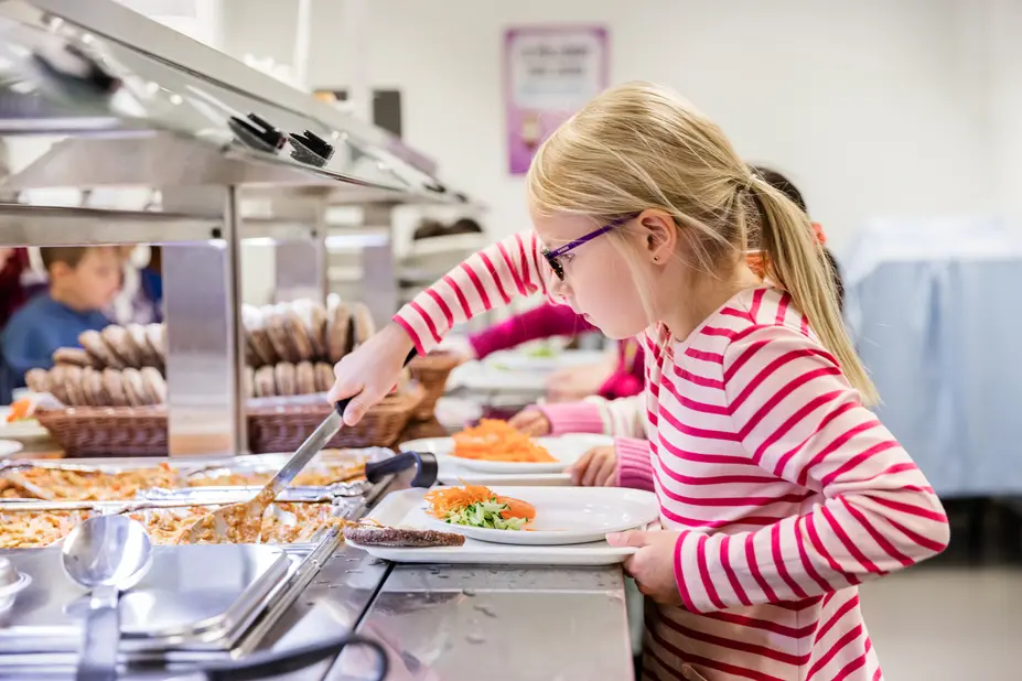A pupil taking school lunch.
