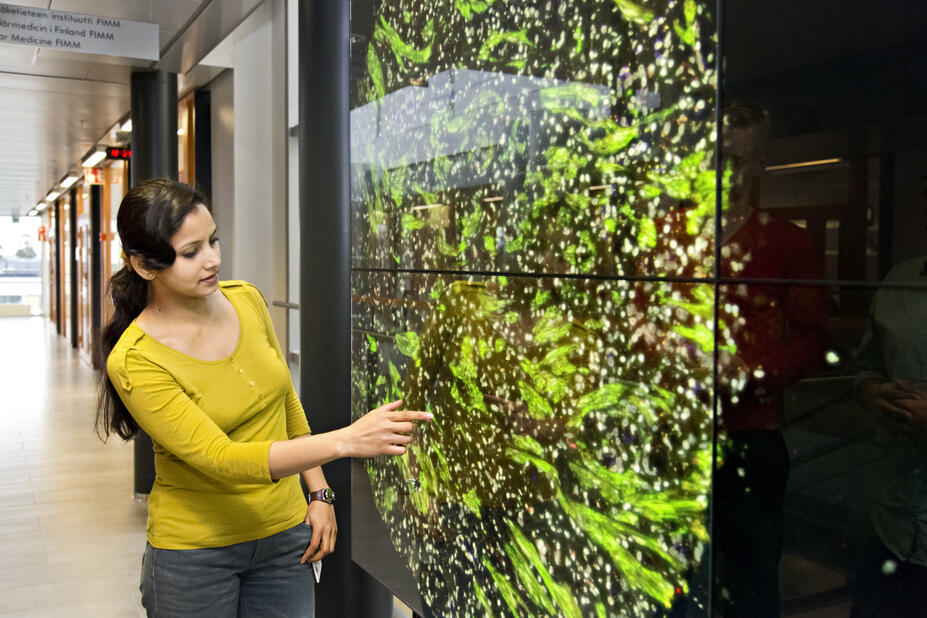 Woman touching a smart screen.