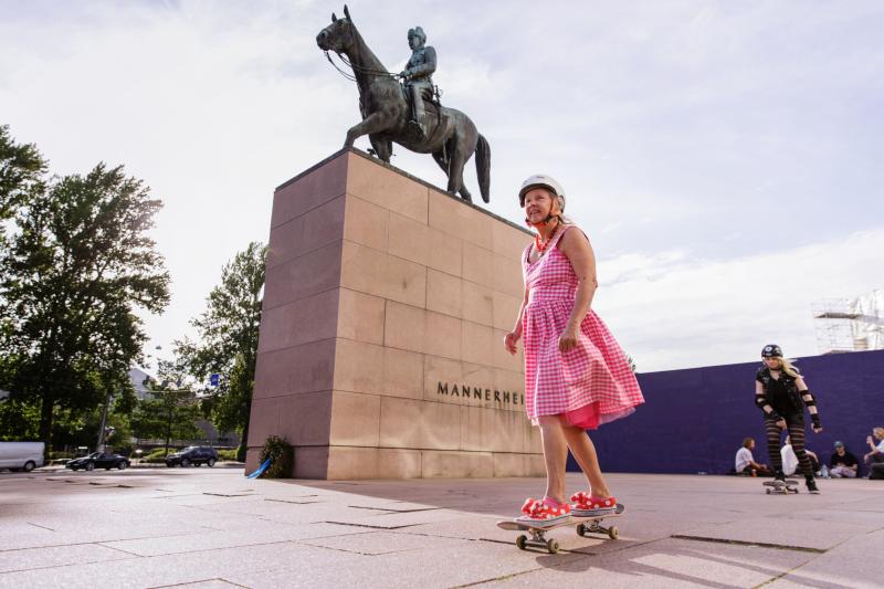 Nainen skeittaa Mannerheimin patsaan edessä