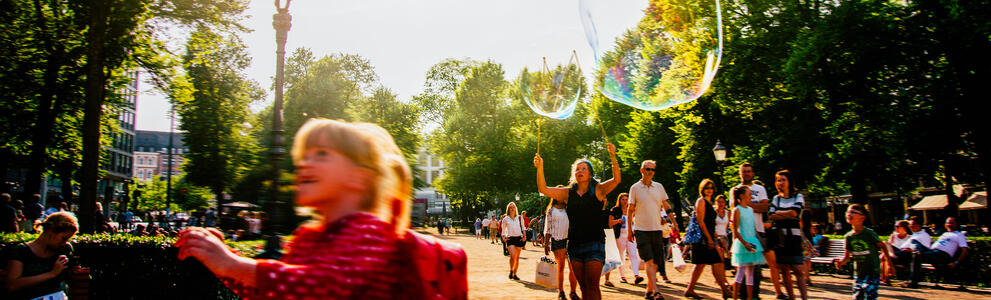 A child blows soap balloon in Esplanadi park in the centre of Helsinki.