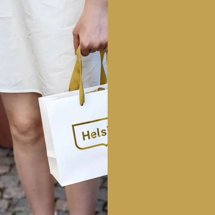 Kultaisella Helsinki tunnuksella varustettu paperikassi