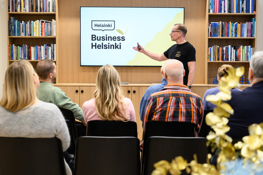 A man giving a presentation about Business Helsinki