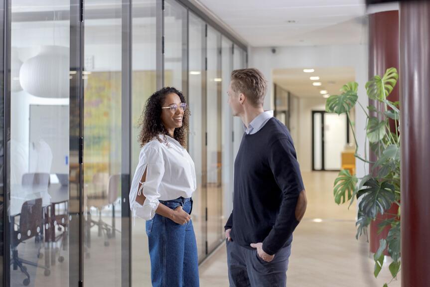 Two people in a hallway.