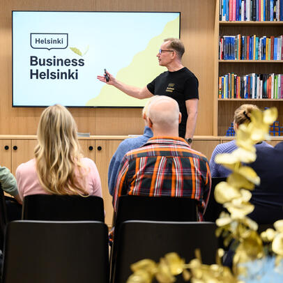 A man giving a presentation about Business Helsinki