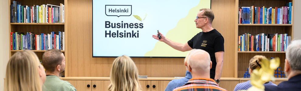 A man giving a presentation about Business Helsinki